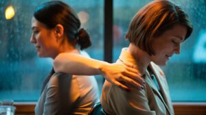 Illustration of a light hand-on-shoulder touch during an apology to signal reassurance and facilitate forgiveness